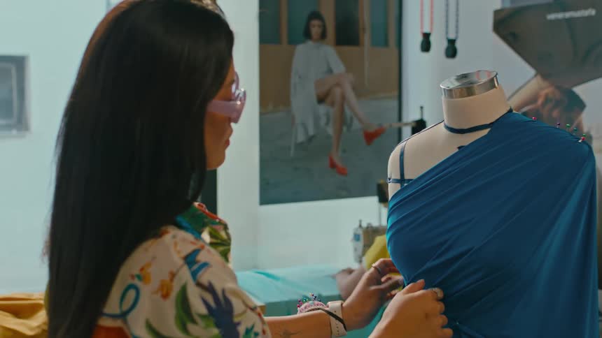 Stylist woman analyzing the mannequin with a blue dress