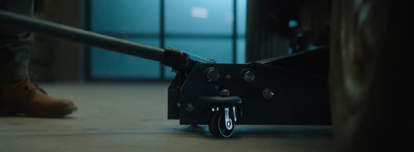 Platform climbing the side of a car in a garage