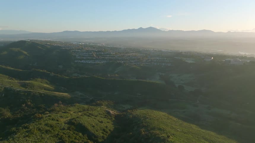 A large suburb on a plateau with mountain ranges nearby