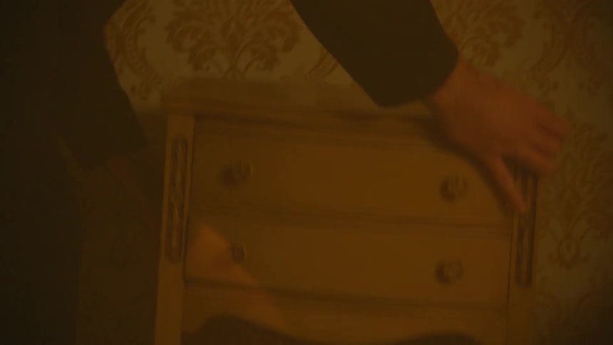 Person picking up a small closet indoors