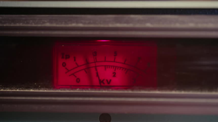 A red ruler with numbers and a pointer that moves to the number three