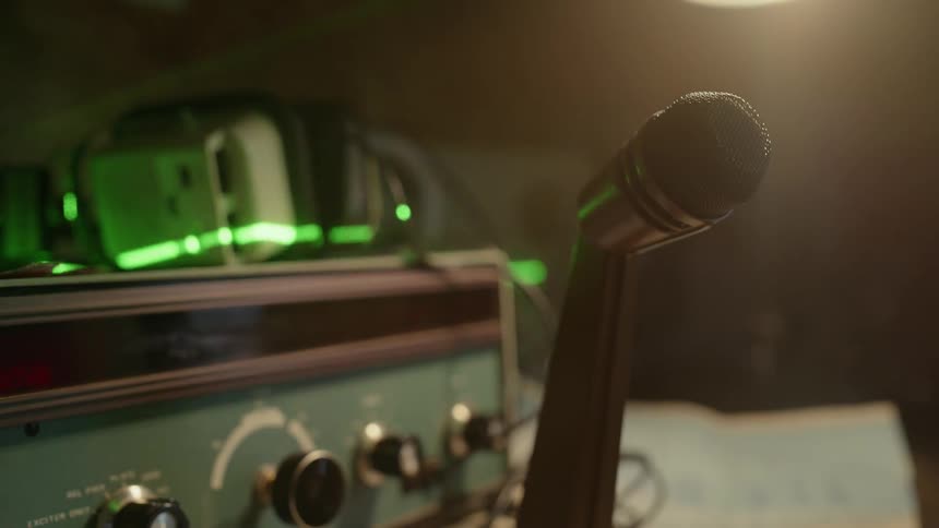 A microphone is hooked up to an old radio