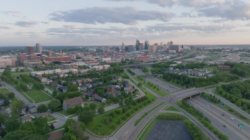 Aerial view of a cityscape during dusk with a clear sky and buildings in the distance