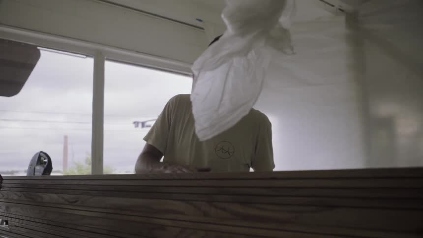 A man rubs a piece of wood