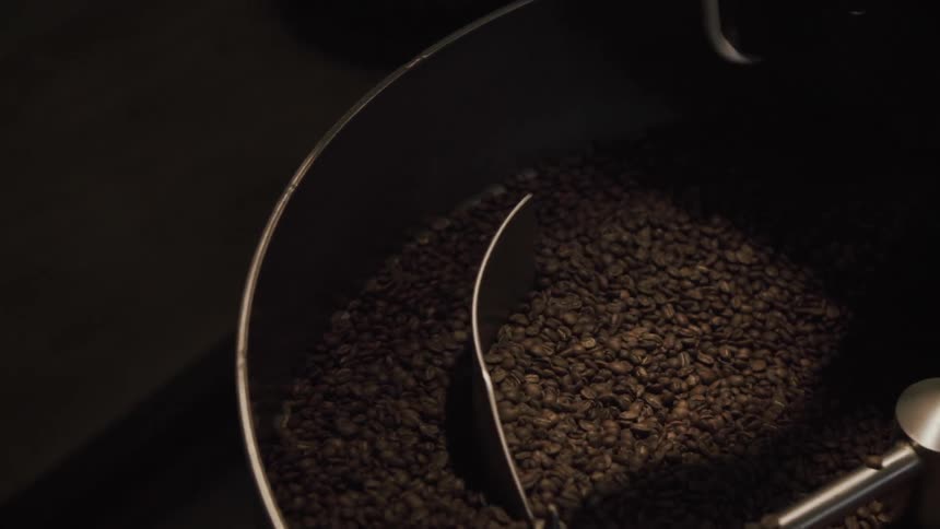 Coffee beans are being stirred in a roasting machine