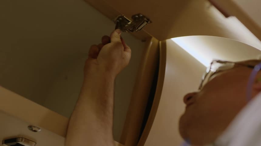 Man screwing one drawer cabinet