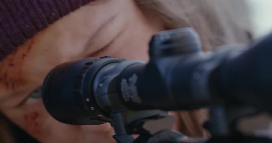Closeup of a concentrated person using a sniper