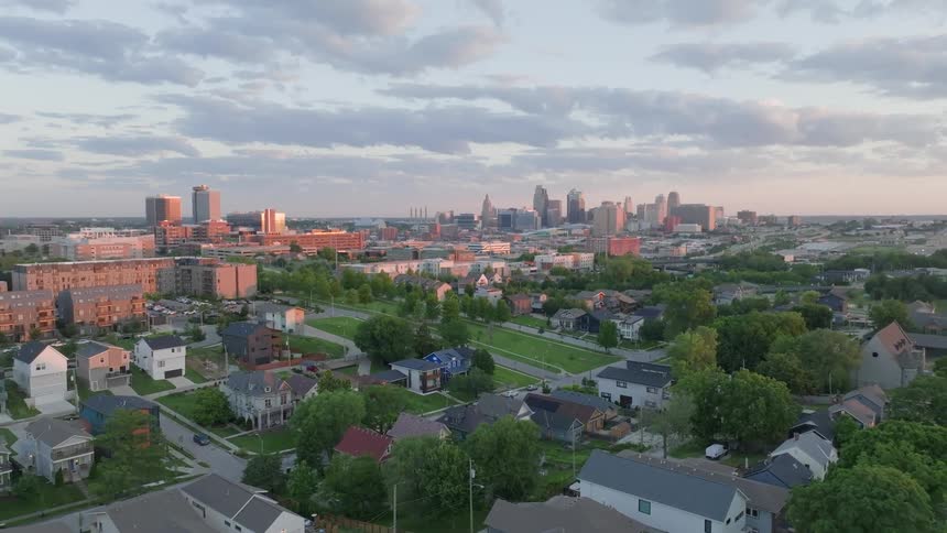 Clouds pass over city before passing over residential neighborhood