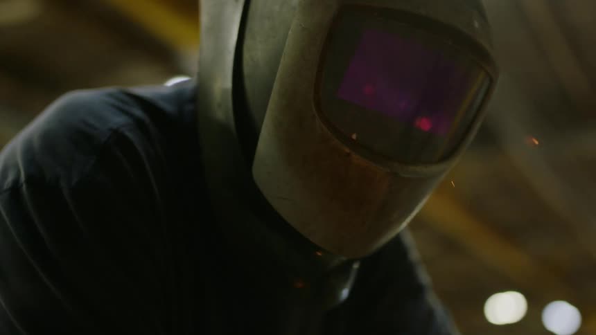 A welder is using his torch