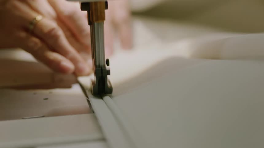 Hand sewing a white fabric