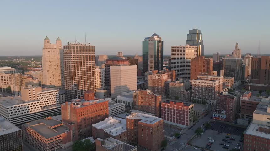 Short buildings cast shadows on taller buildings in the city