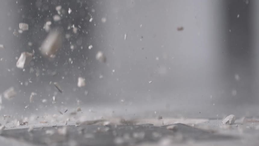 A sledge hammer smashes against the ground