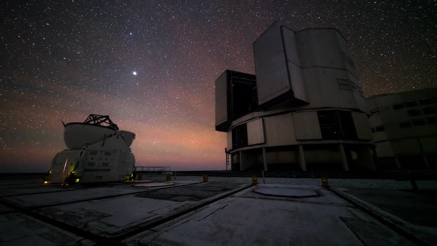Two observation antennas facing the night sky with several stars