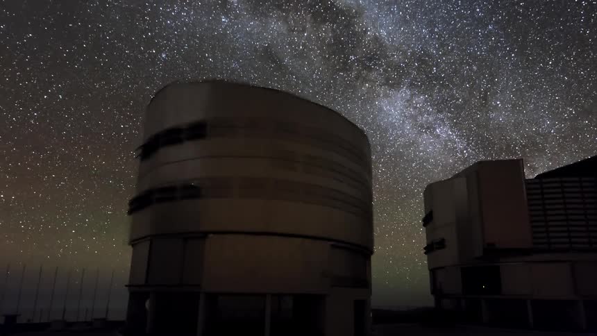 Large telescopes pointing at a starry night sky