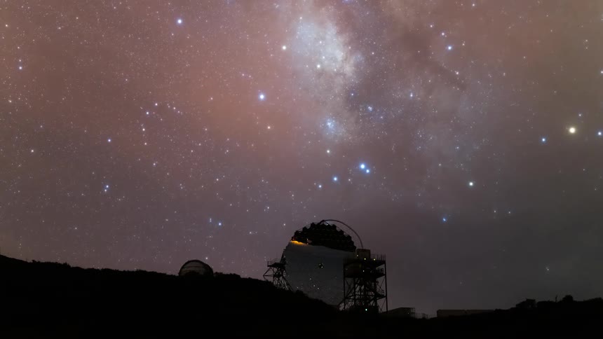 An observatory in a dark place with the starry sky and mists passing by