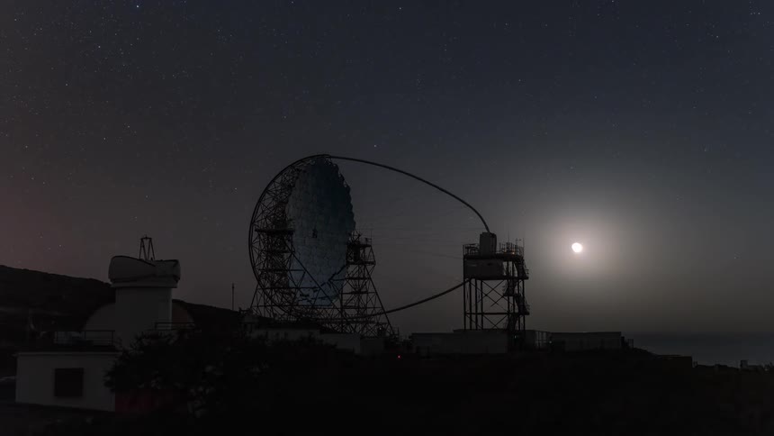 An observatory on a coast as the moon sets
