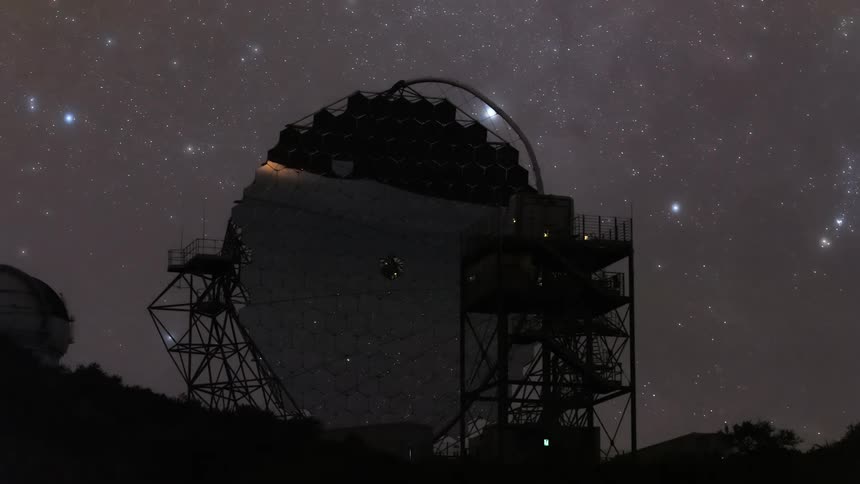 A huge observatory telescope in a place with dark starry sky