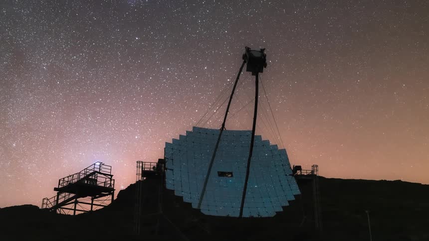A radio telescope with a reflective surface under a starry night sky scans the cosmos for signals