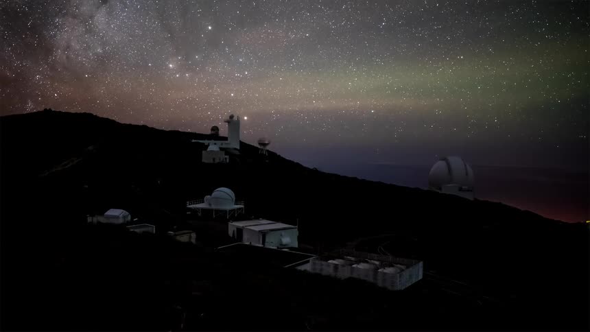 Time lapse footage of an observatory beneath a starry night sky