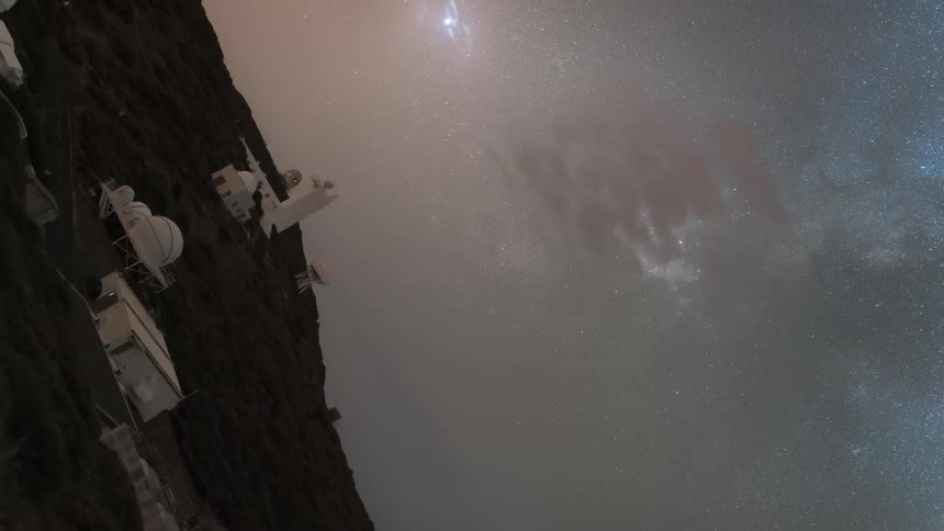 Astronomical observatory in a mountainous region under a starry sky