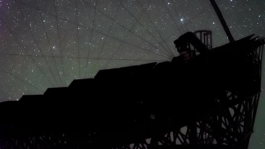 The telescope surface reflects the stars
