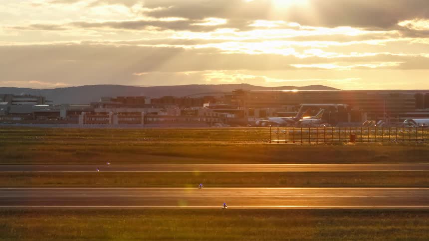 Cars drive along several highways running by an airport