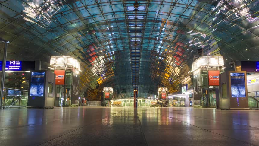 An interior had several people passing quickly and several machines with lights