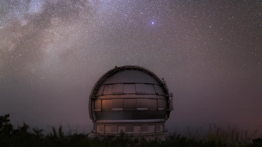 An observatory is rotating side to side as the day passes and it becomes night and the sky is full of stars