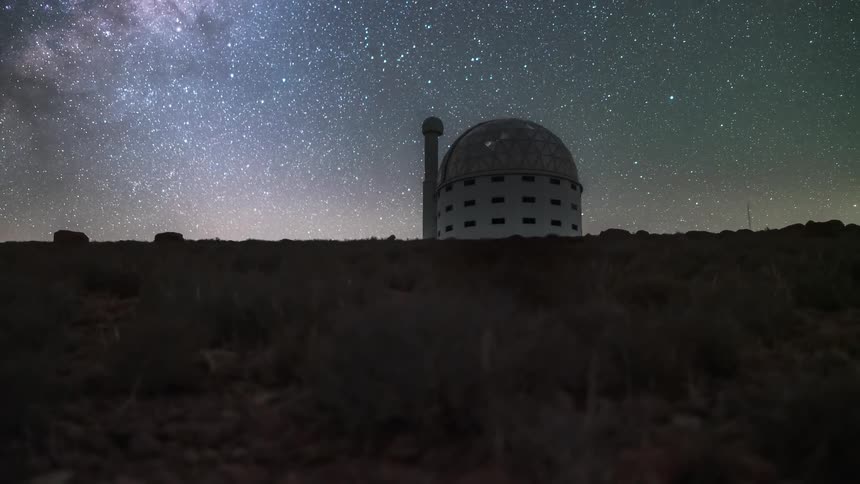 An observatory pointed at cells in a region with a starry sky all bright at night