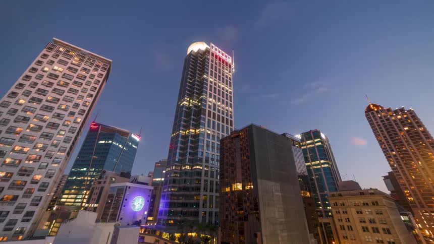 Metropolises with skyscrapers getting lit up at night