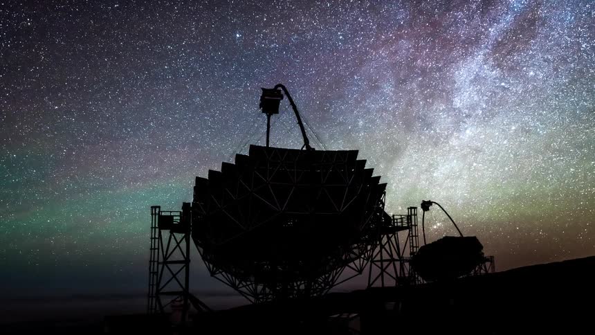 Radio telescopes spin as the milky way comes out at night