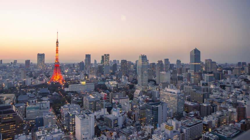 Panorama of a metropolis with large buildings and dusk with the city becoming illuminated