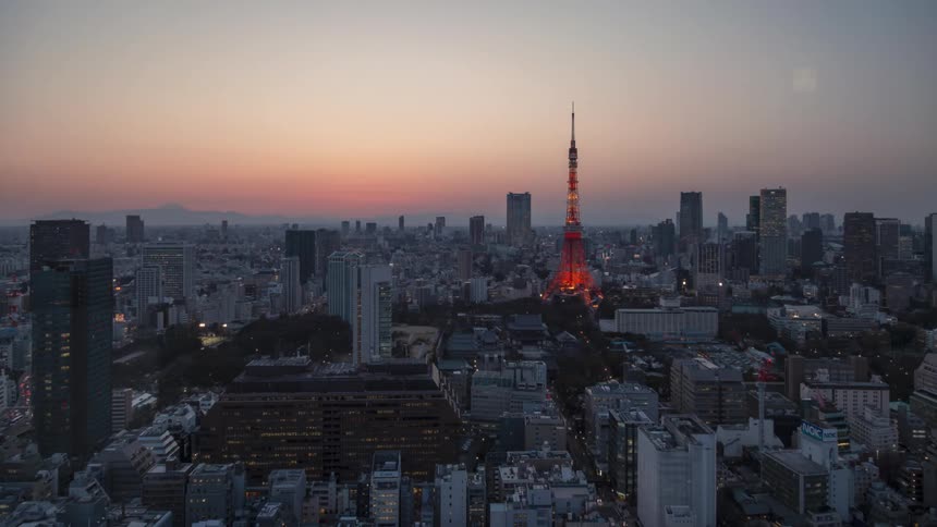 As the sun sets a city lights up for the night