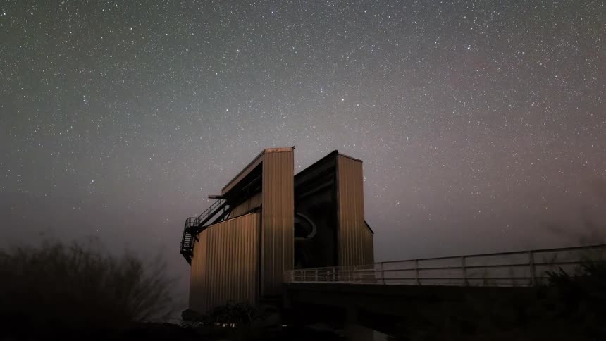 Observatory at night illuminated against a starry sky with the milky way