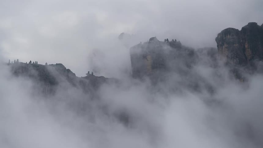 Smoke rises from a volcanic mountainous landscape