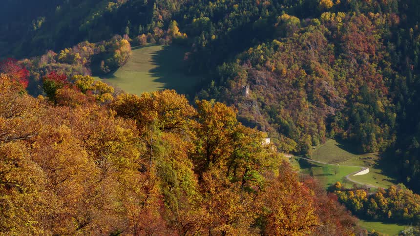 Aerial landscape of mountains with autumn vegetation and houses in the background