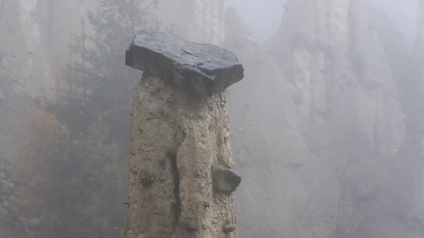 Unique flattopped rock formation shrouded in mist