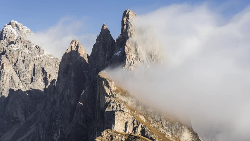 The clouds floating around rugged mountain peaks
