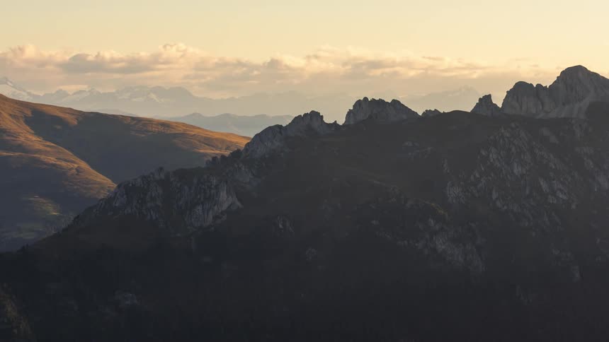 A long line of clouds move over mountains