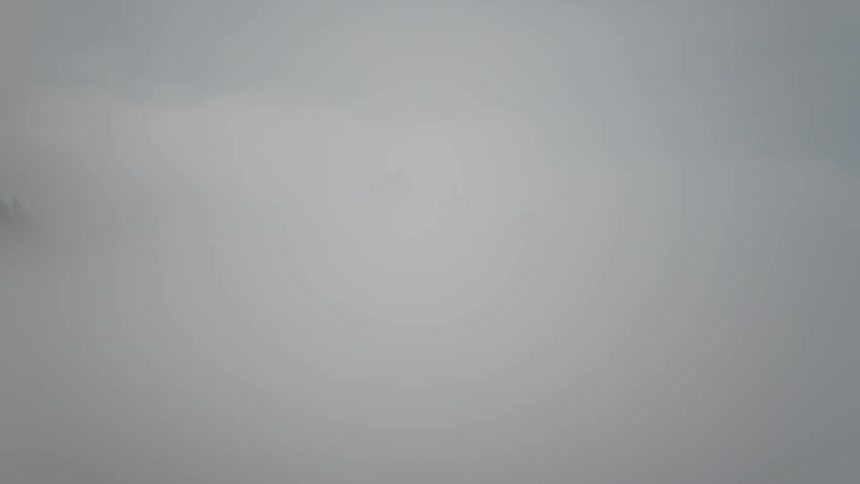Sea of mist on a mountainous hill with a castle in the background