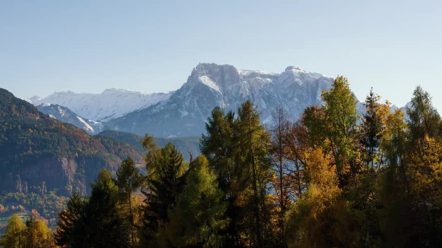 An autumn forest hides a majestic and deep mountain valley