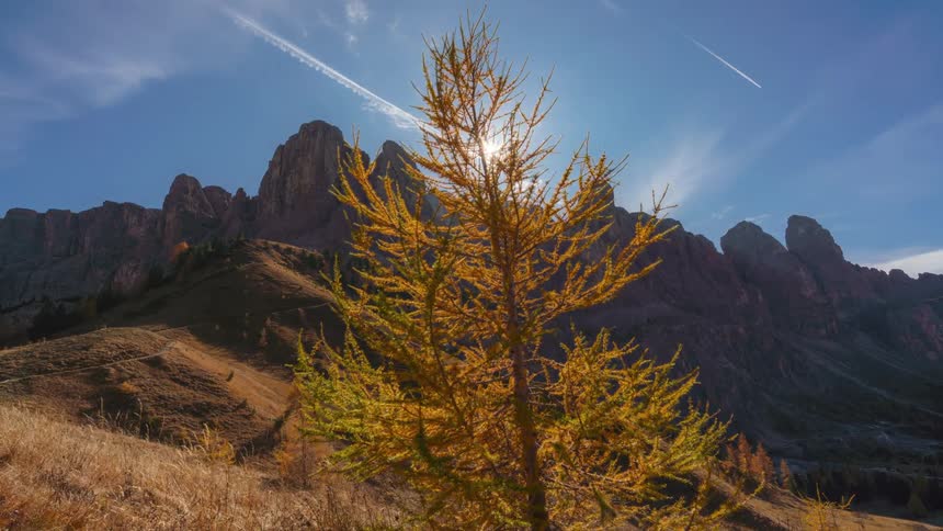 Rocky peaks in a mountainous valley against a blue sky