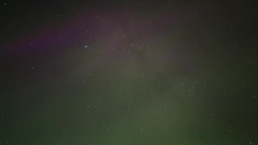 Purple and green aurora flares in outer space