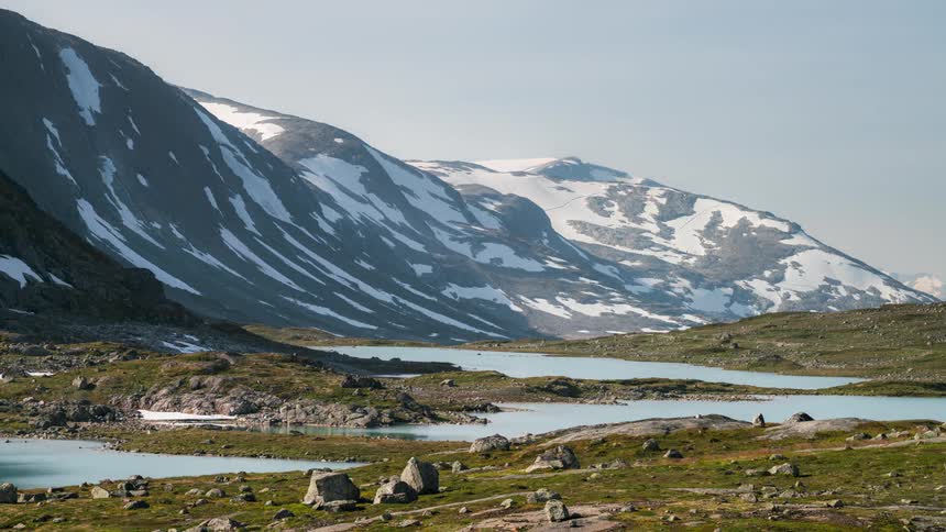 Mountain landscape with snow and small lakes