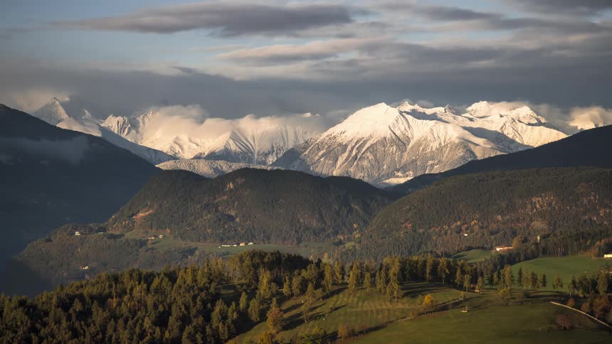 A mountainous valley on a cloudy day during the spring season
