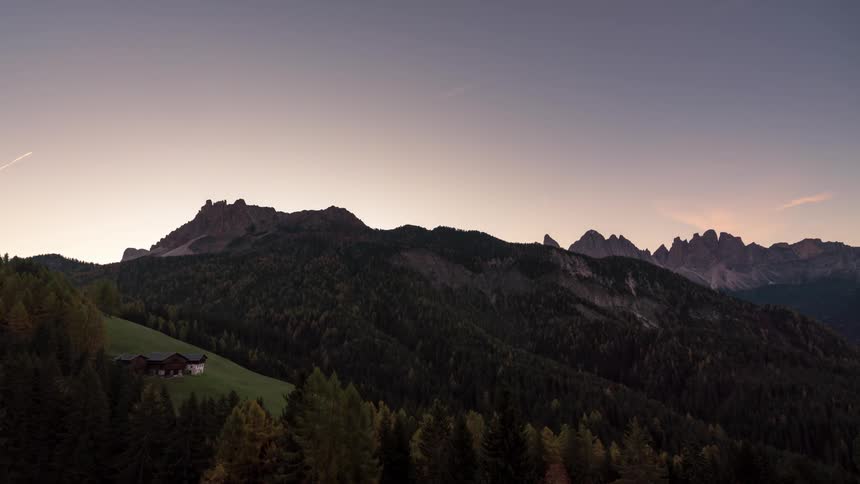 Mountainous landscape with vegetation on a day of dawning sky in different tones