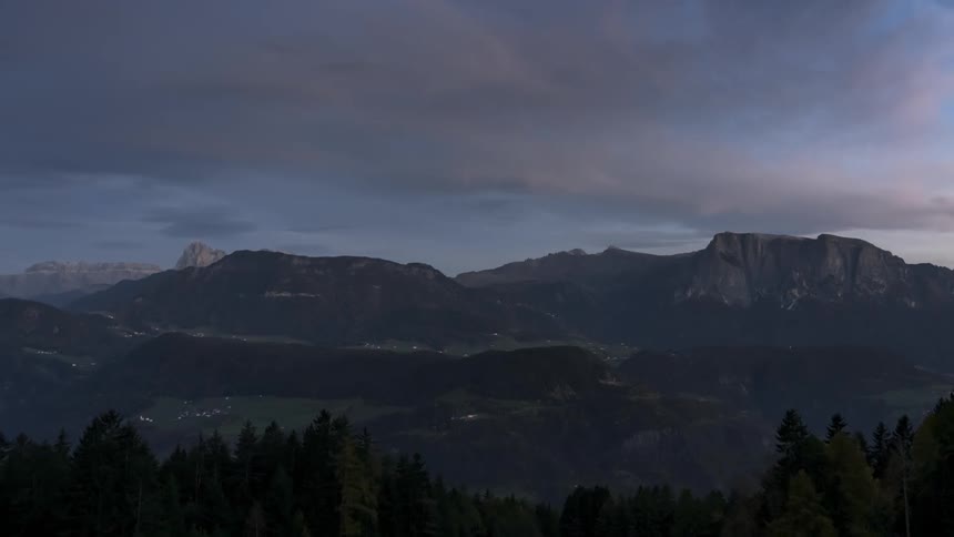A tall mountain range is at the end of the valley