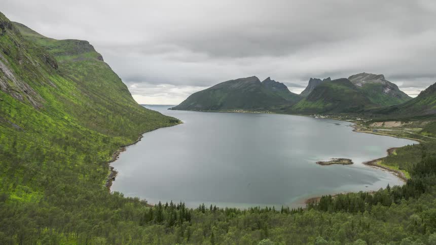 Time lapse of clouds rolling over a lake in the mountains