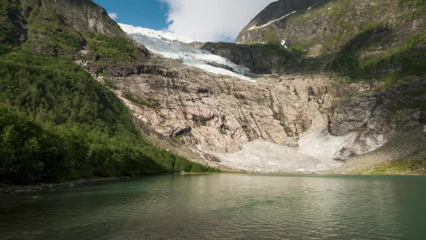 A lake sits at the foot of the mountain