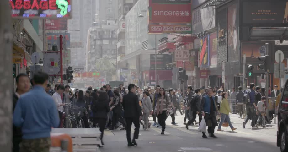 Pedestrians walking on a busy urban street